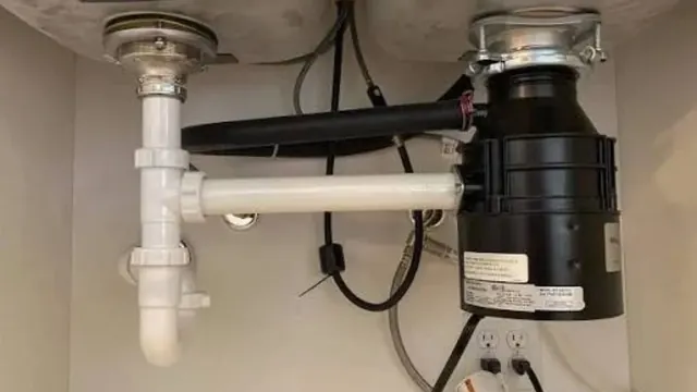 Garbage disposal and drain pipes installed under a kitchen sink